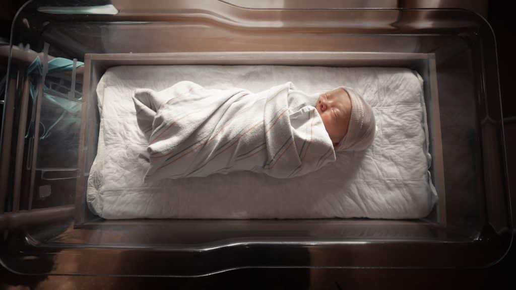 new born baby wrapped in blanket 